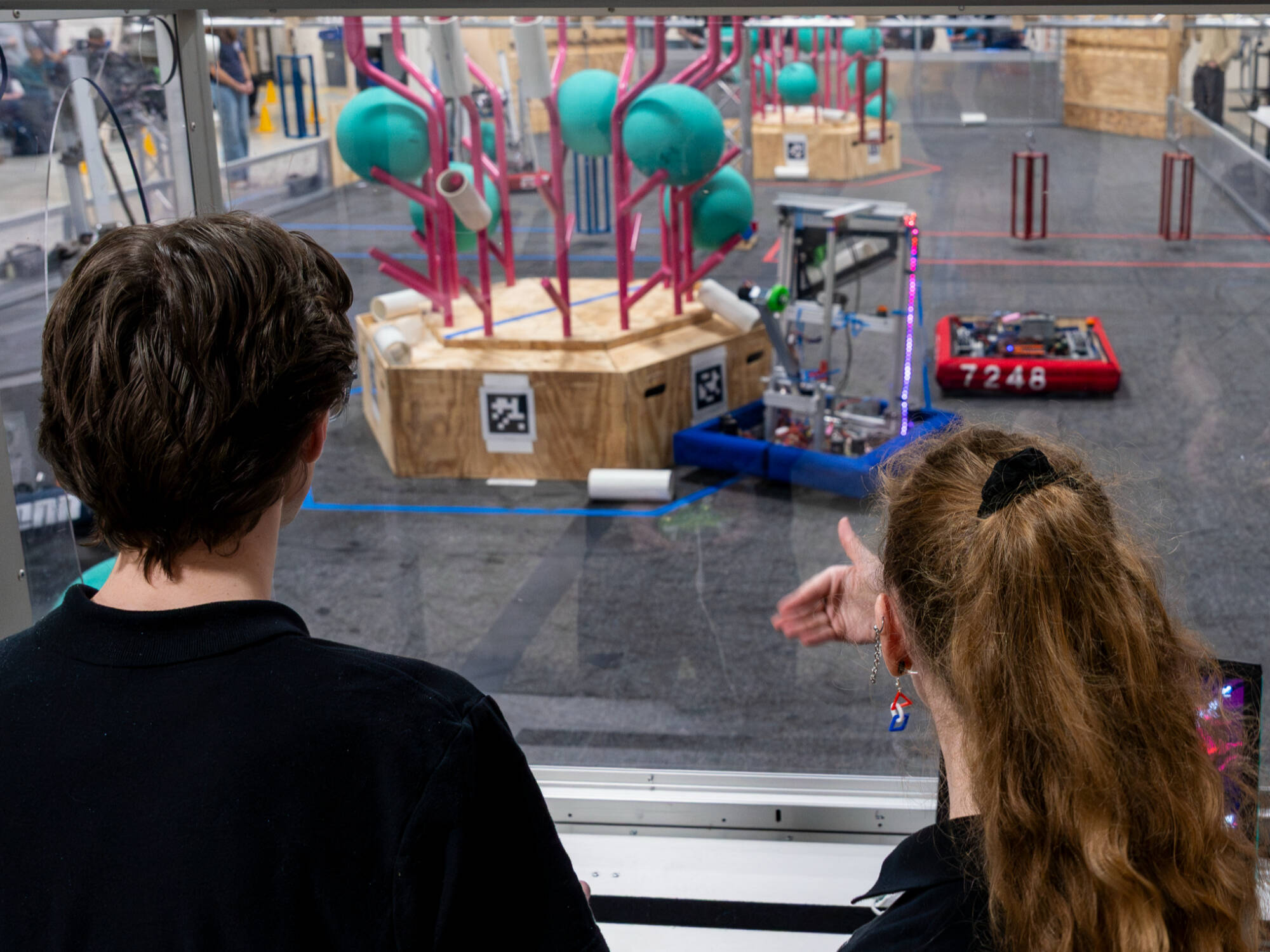 (From left) Product design and manufacturing engineering major Logan Weisner and computer engineering major Jessa pilot a robot during the GVSU FANGV Ri3D Robotics Competition at the Innovation Design Center o...